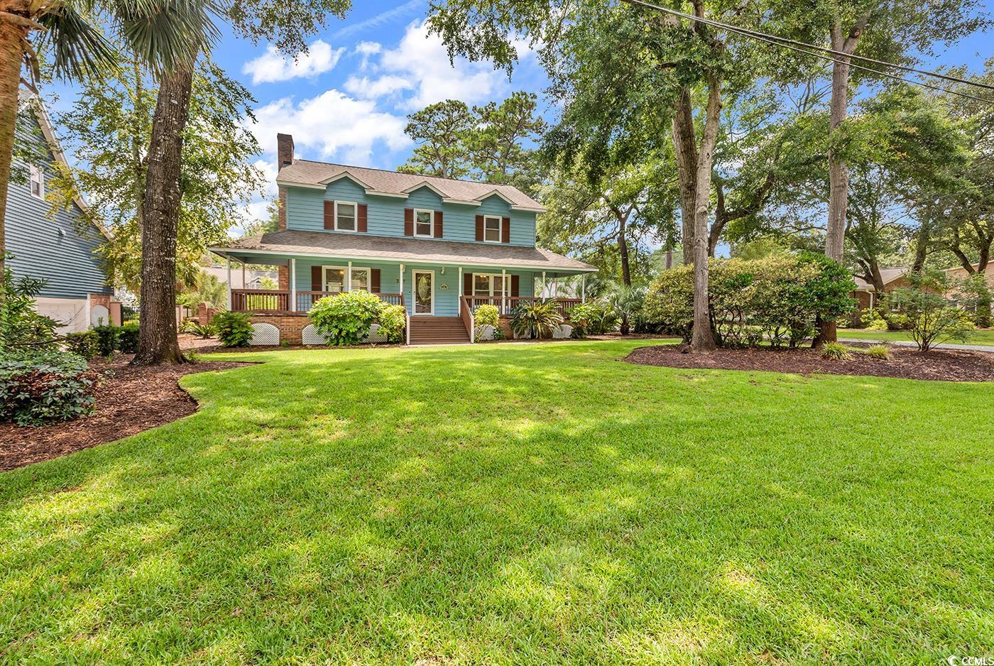 317 14th Avenue North Surfside Beach, SC 29575 - Photo 36 of 40 Farmhouse featuring a chimney, covered porch, and