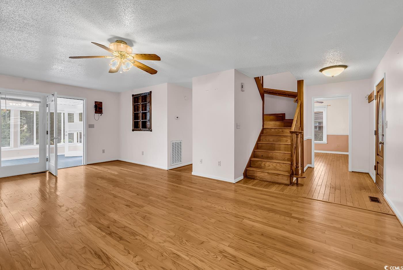 317 14th Avenue North Surfside Beach, SC 29575 - Photo 4 of 40 Unfurnished living room featuring a textured ceili