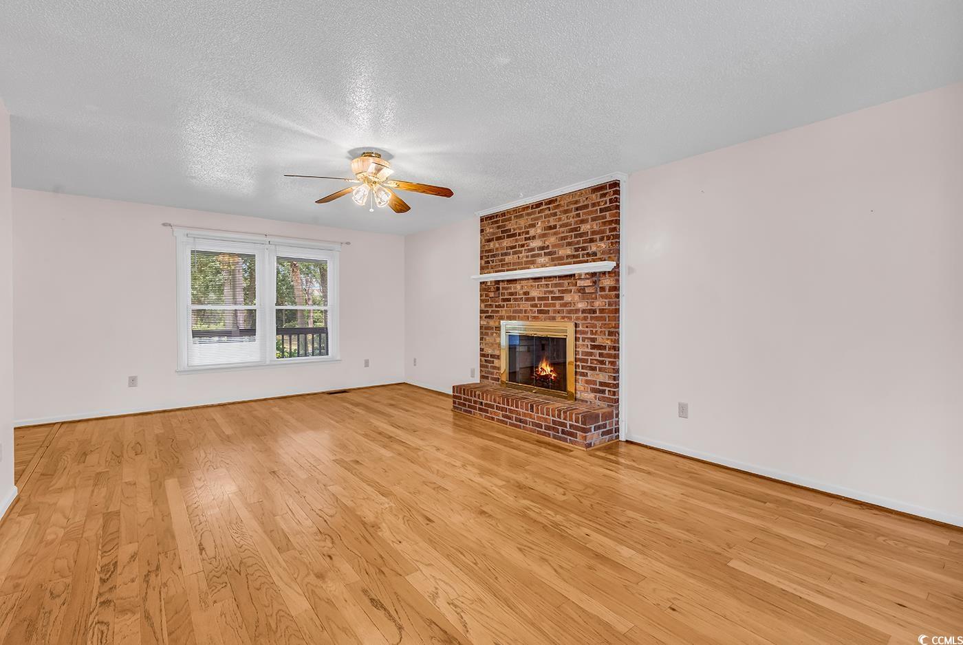 317 14th Avenue North Surfside Beach, SC 29575 - Photo 6 of 40 Unfurnished living room with a ceiling fan, a text