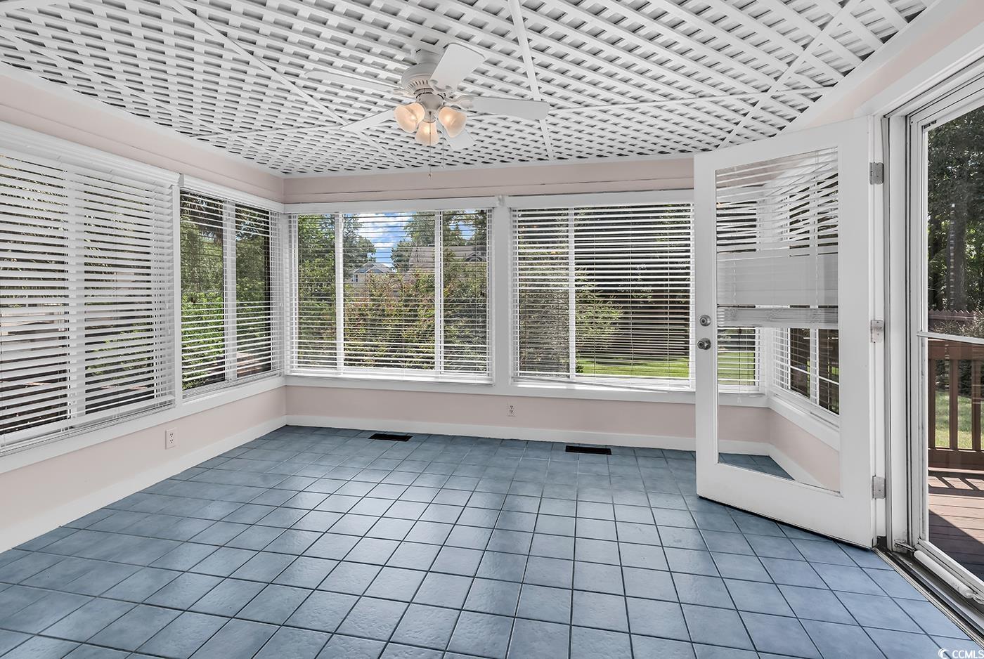 317 14th Avenue North Surfside Beach, SC 29575 - Photo 7 of 40 Unfurnished sunroom with tile patterned floors and