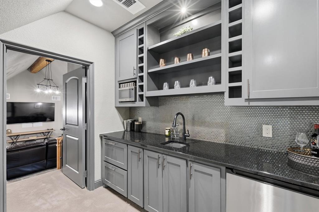 476 Hidden Valley Lane Coppell, TX 75019 - Photo 20 of 40 a kitchen with stainless steel appliances a sink and a refrigerator