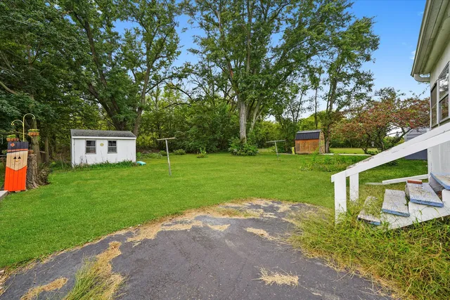 a view of a house with backyard and a garden