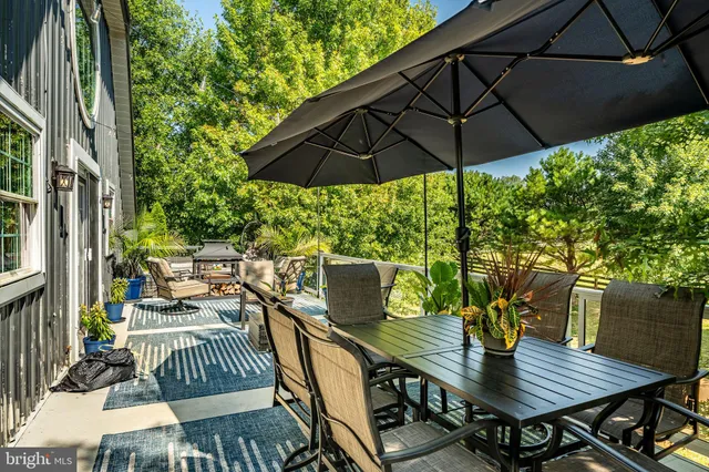 a view of a balcony with wooden floor and outdoor seating