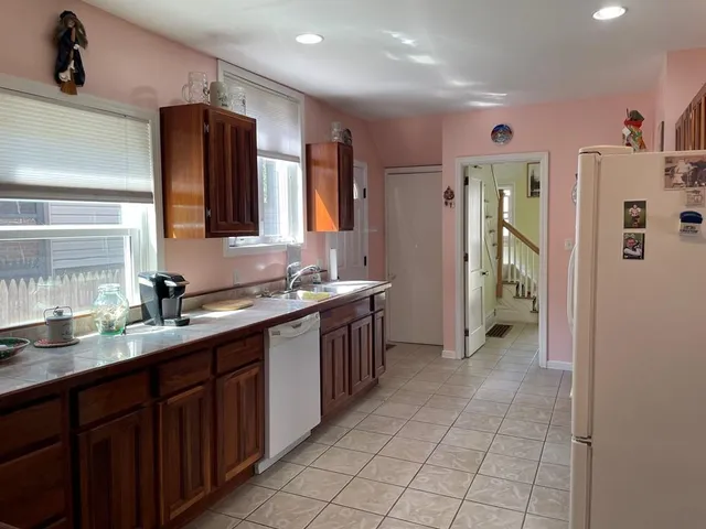 a large kitchen with a sink and cabinets