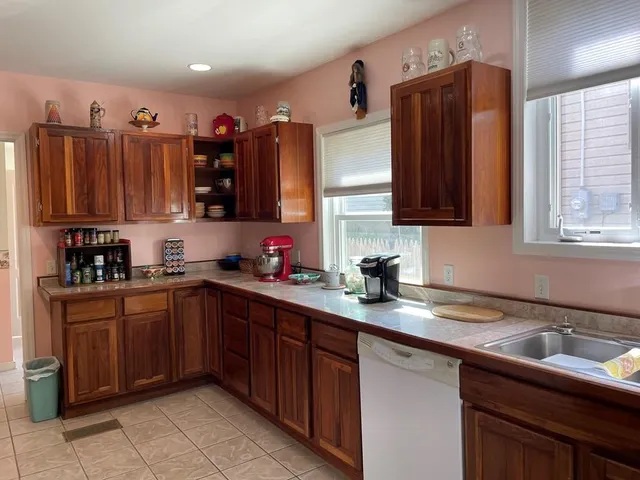 a kitchen with granite countertop a sink stainless steel appliances and cabinets