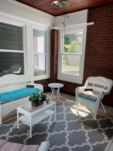 a living room filled with furniture and a potted plant