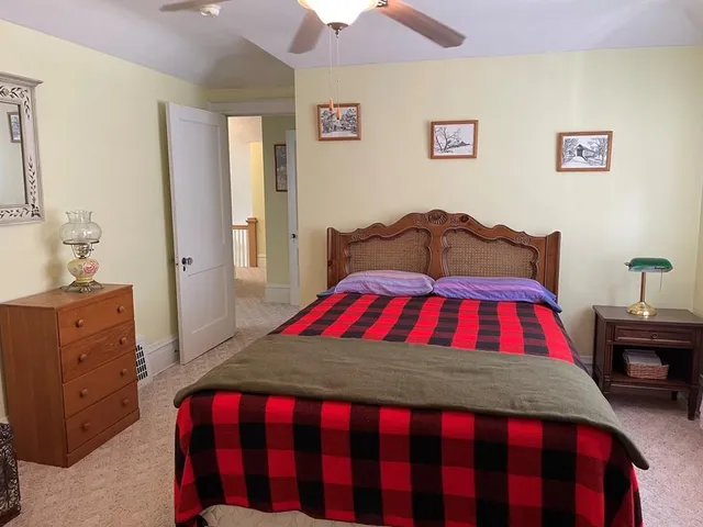 a bedroom with a bed and a dresser