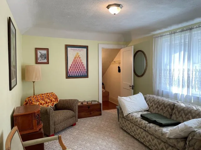 a living room with furniture and a mirror