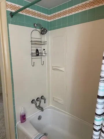 a bathroom with a bathtub and shower