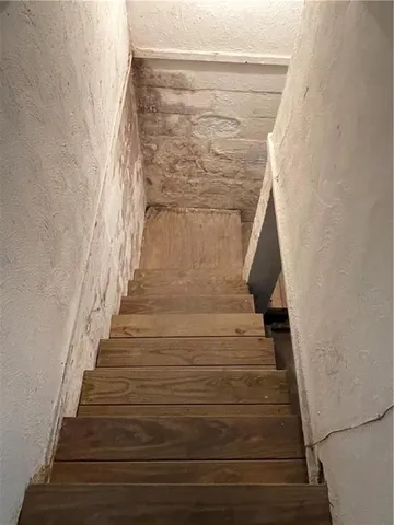 a view of staircase with white walls