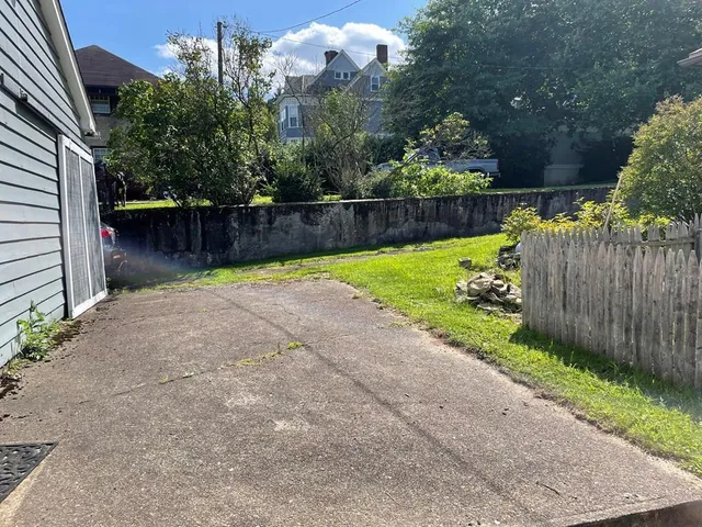 a view of a backyard with wooden fence