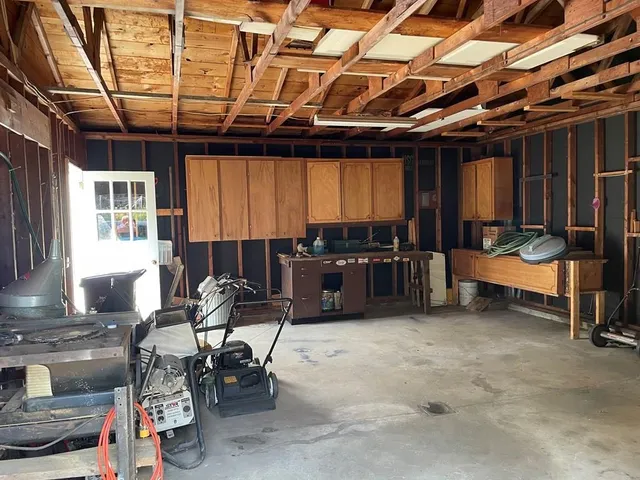 a storage room with lots of furniture and a water heater