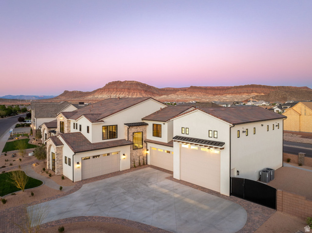 4871 South Homestead Way Washington, UT 84780 - Photo 128 of 151 Mediterranean / spanish-style house featuring stucco siding, concrete driveway, stone siding, and a mountain view