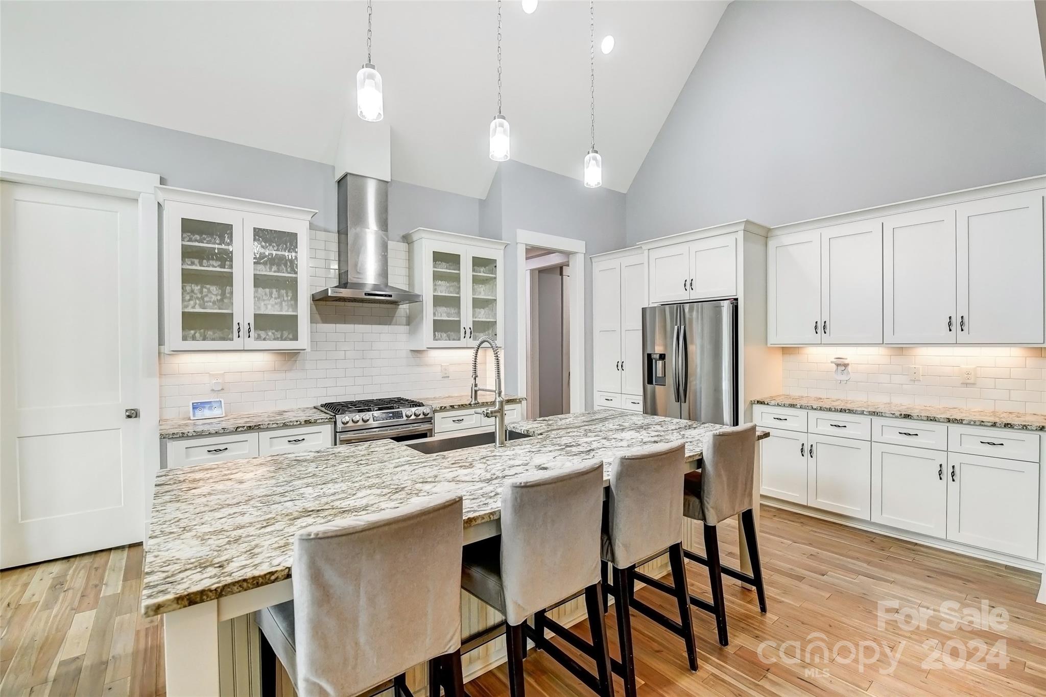 444 Evergreen Road Clover, SC 29710 - Photo 8 of 47 a kitchen with stainless steel appliances granite countertop a dining table chairs stove refrigerator and cabinets