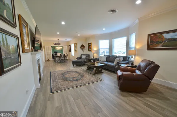 a bathroom with a granite countertop sink toilet and mirror