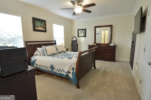 a spacious bedroom with a bed and a window