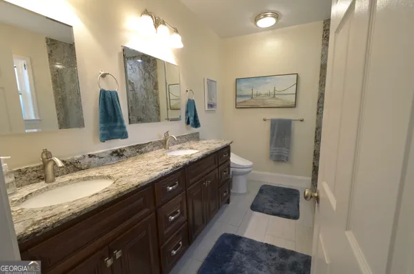 a view of a room with a ceiling fan and window