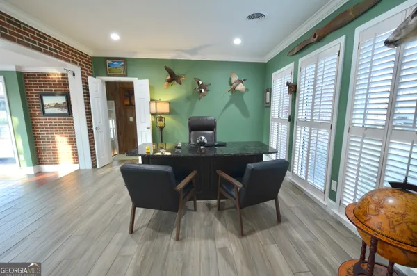 a view of deck with a floor to ceiling window and wooden fence