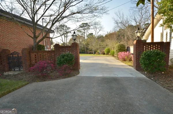 a kitchen with stainless steel appliances granite countertop a sink stove a refrigerator and island with wooden floor