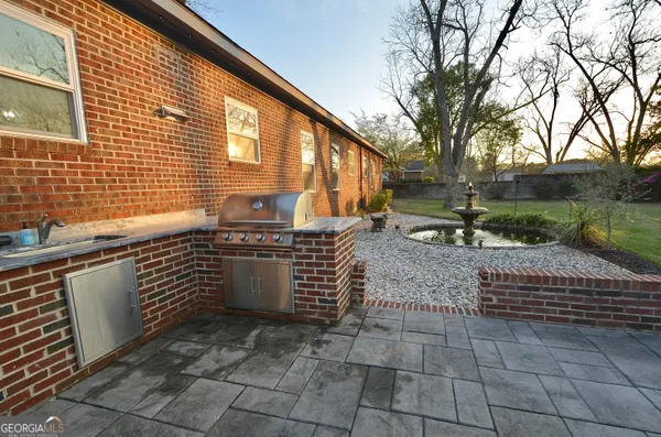 a kitchen with a stove a sink and a refrigerator