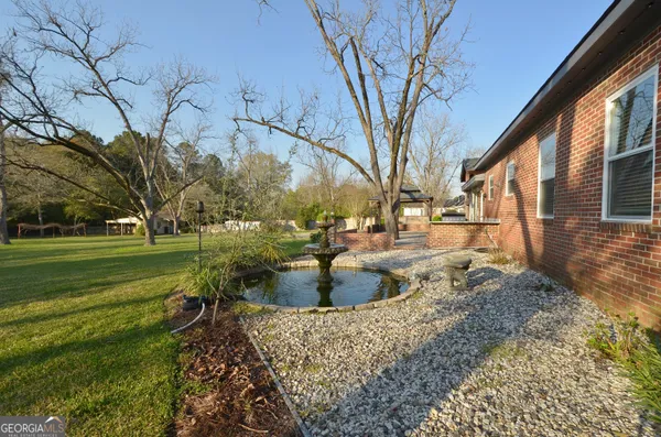 a kitchen with granite countertop counter space a sink appliances and a window