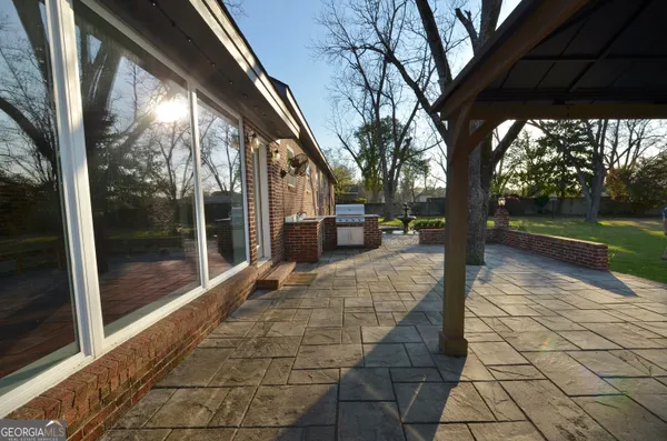 a kitchen with granite countertop stainless steel appliances a refrigerator a sink a stove a counter space and cabinets