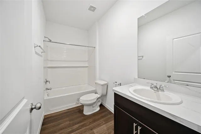 a view of a house with a yard and potted plants