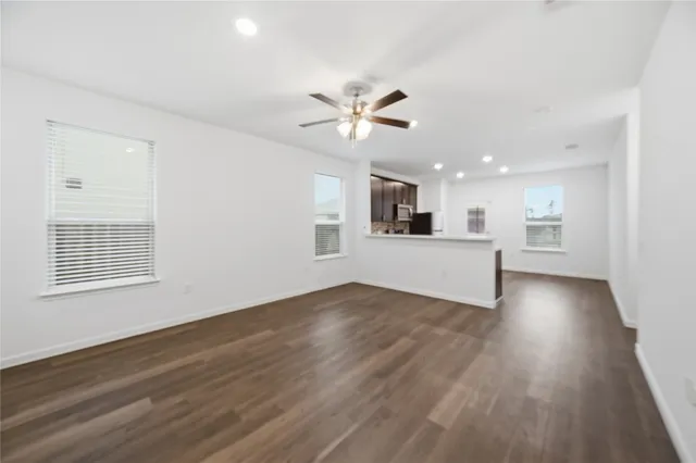 a kitchen with granite countertop stainless steel appliances cabinets a sink and a window