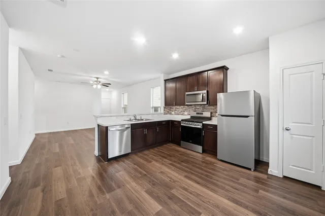 a bedroom with a bed chandelier and a window