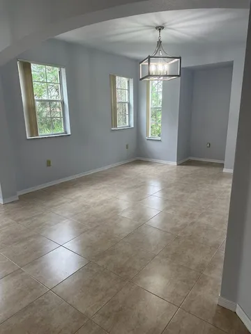 an empty room with windows and entrance