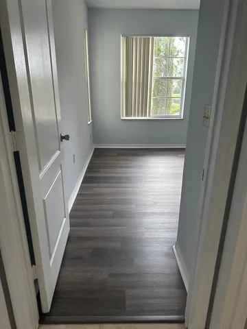a view of a room with wooden floor and windows