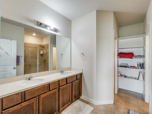 a bathroom with a tub sink and mirror