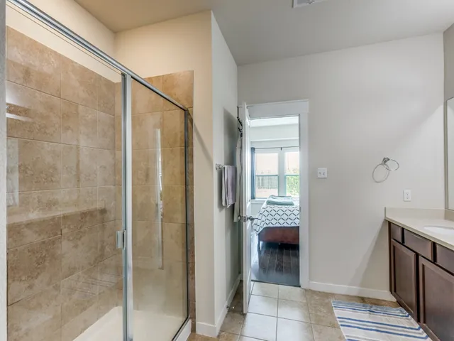 a bathroom with a shower and a sink
