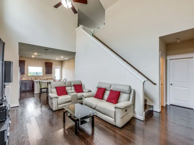 a living room with furniture and wooden floor
