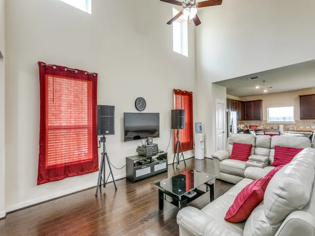 a living room with furniture a rug and a window