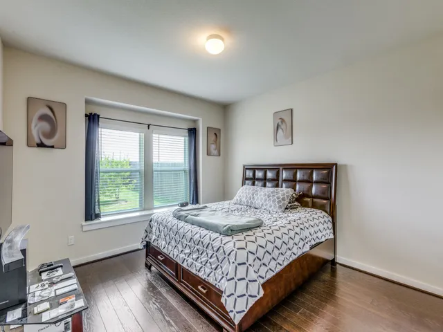 a bedroom with a bed and window