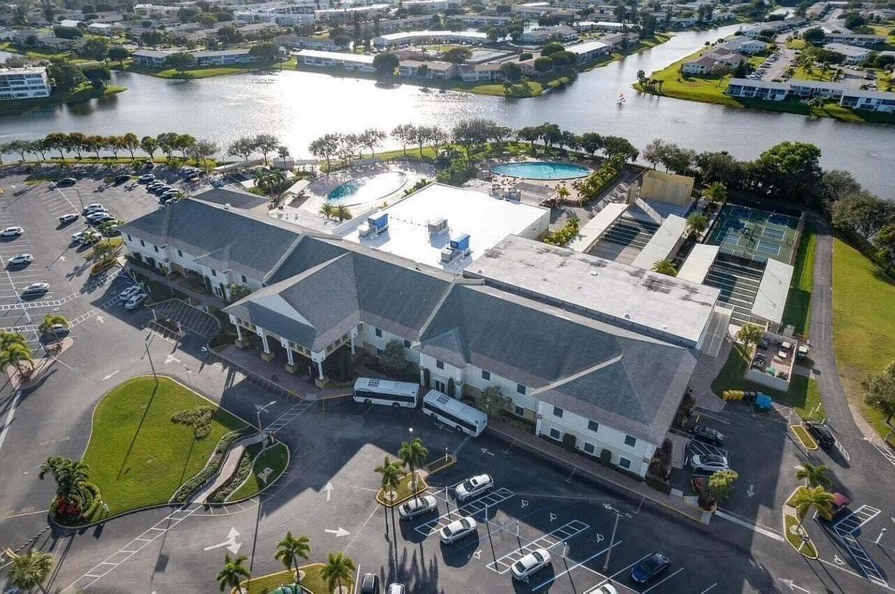 128 Canterbury F, Unit 128 West Palm Beach, FL 33417 - Photo 17 of 17 an aerial view of a house with a lake view