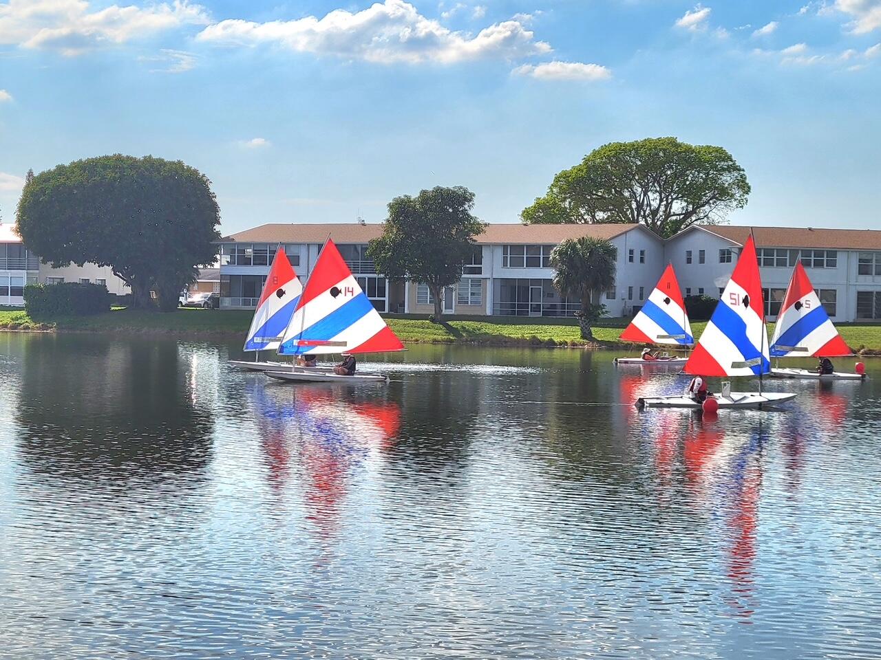 128 Canterbury F, Unit 128 West Palm Beach, FL 33417 - Photo 9 of 17 a view of swimming pool with a lake view