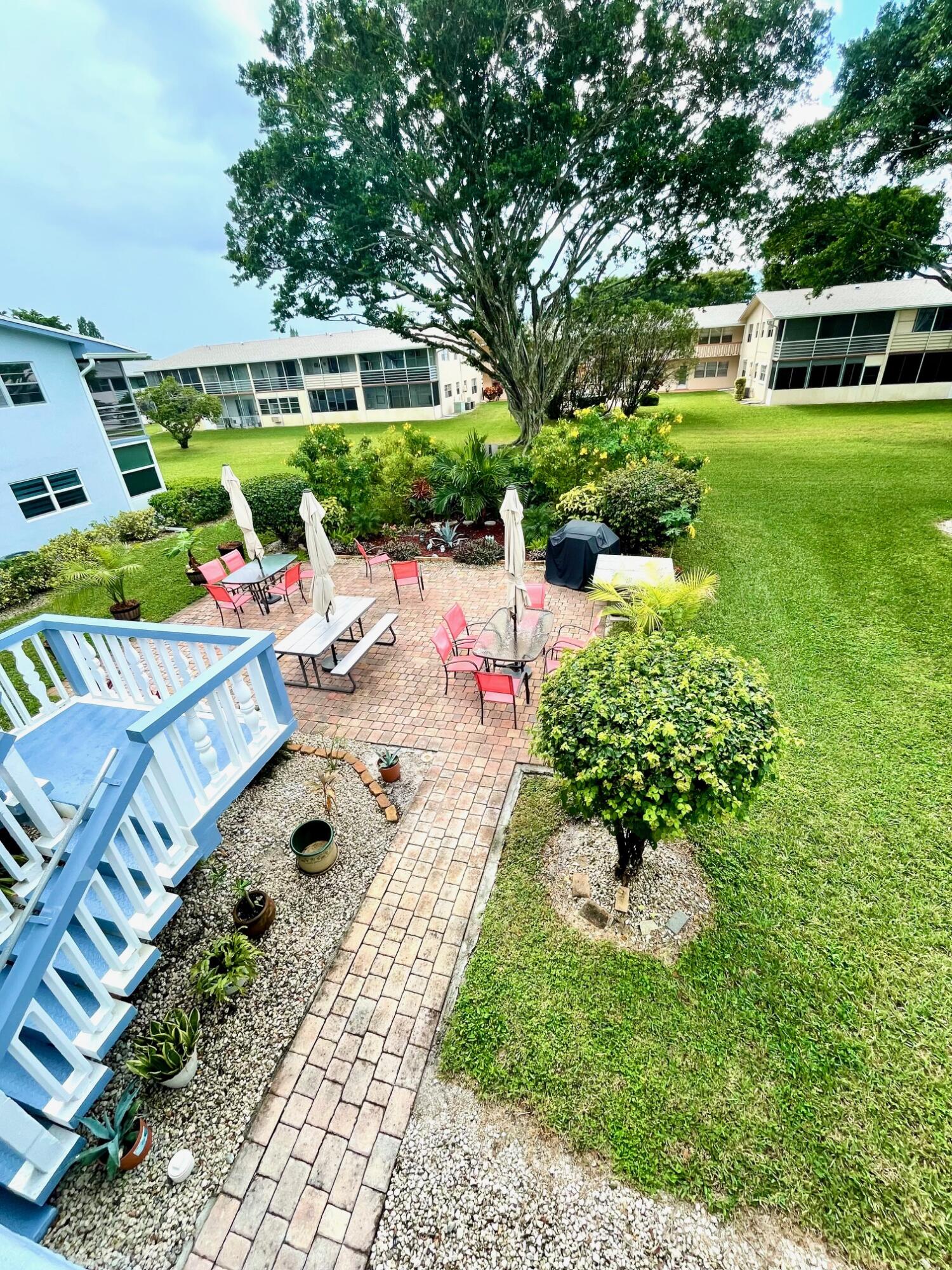 128 Canterbury F, Unit 128 West Palm Beach, FL 33417 - Photo 10 of 17 a view of a house with a yard