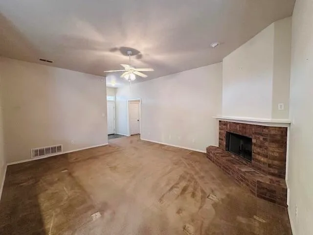a view of empty room with a fireplace