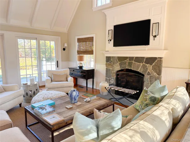 a living room with furniture a fireplace and a flat screen tv