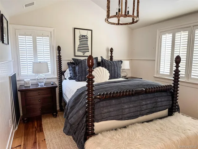 a bedroom with a bed dresser and a window