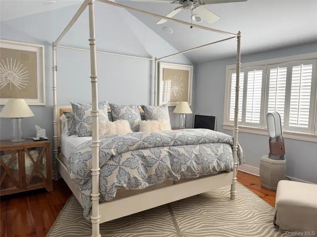 a bedroom with a large bed and a window