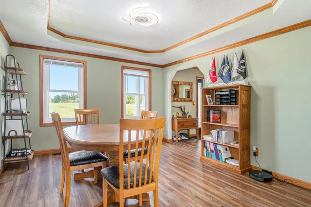 a dining room with furniture and wooden floor