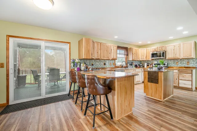 a kitchen with a table chairs refrigerator and cabinets