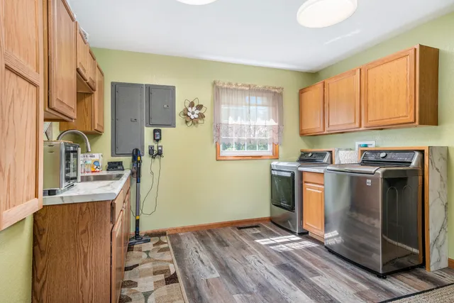 a kitchen with granite countertop a stove a sink and a refrigerator
