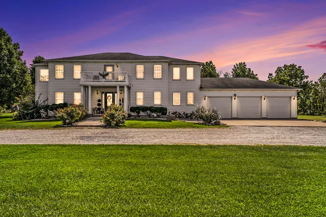 a front view of a house with a garden and plants