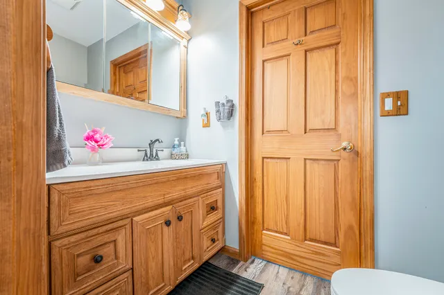 a bathroom with a sink a vanity and a window