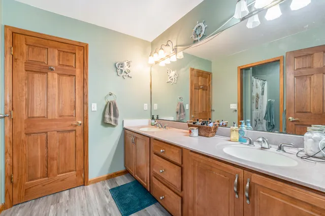 a bathroom with a double vanity sink and a mirror
