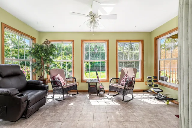 a living room with furniture and floor to ceiling windows